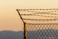 Mesh fence with barbed wire on top Royalty Free Stock Photo