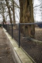 Mesh fence on concrete base Royalty Free Stock Photo