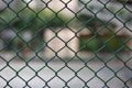 Mesh fence panel on blurred Background. Royalty Free Stock Photo