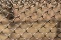 Mesh rabitz , texture of weaving mesh network link. Close up of a fence. barrier on way. metal grid close-up. rusty mesh Royalty Free Stock Photo