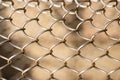 Mesh rabitz , texture of weaving mesh network link. Close up of a fence. barrier on way. metal grid close-up. rusty mesh Royalty Free Stock Photo