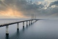 Mesmerizing aerial view of the bridge between Denmark and Sweden under the cloudy sky