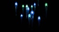 Glowing blue and green glass icicle lights hang Royalty Free Stock Photo
