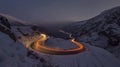 A mesmerizing display of car light trails weaving through the steep pas