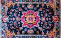 A mesmerizing mandala-inspired rug featuring a kaleidoscopic array of vivid colors and intricate, concentric floral