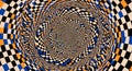 Mesmerizing optical illusion vortex of checkered pattern drawing viewer into abstract dimension Royalty Free Stock Photo