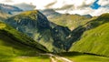 Mesmerizing panorama of honey on the green wavy natural mountain hills of Georgia on a sunny summer day