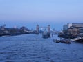 Mesmerizing River Thames at twilight with the full moon shining behind Tower Bridge in London