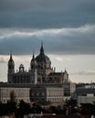 Mesmerizing scene of the Almudena Cathedral in Madrid, Spain with a gray hazy cloudy sky