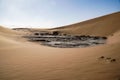 Mesmerizing scene of a salt and clay pan surrounded by high dunes in Sossusvlei, Namibi