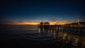 Mesmerizing seascape view with a long wooden jetty entering the calm sea at sunset Royalty Free Stock Photo