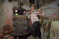 Mesmerizing shot of the attractive farmer pressing grapes with a wine press