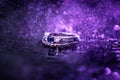 Mesmerizing shot of beautiful  rings on a sparkly purple background Royalty Free Stock Photo