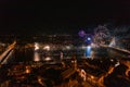 Mesmerizing shot of the cityscape with a beautiful Christmas tree and bright fireworks