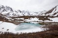 Mesmerizing shot of the Frozen pond in Chugach State Park, Alaska with snowy mountains Royalty Free Stock Photo