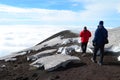 Mesmerizing shot of two tourists visiting Etna volcano in Sicily, Italy