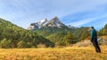 Mesmerizing shot of a young male standing in front of the Pedraforca Saldes Mountain in Spain