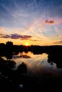 Sunset in autumn, over a city park lake in Cluj-Napoca, Romania with a skyline in the background Royalty Free Stock Photo