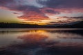 Mesmerizing sunset paints the sky above the tranquil lake