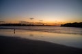 Mesmerizing sunset view at Sunshine Coast and a silhouetted little girl on a riverbank