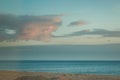 Mesmerizing, tranquil sea with sandy beach at the sunset of beautiful cloudscape
