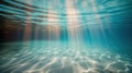 Sun Rays Penetrate Blue Sea Water Illuminating Sandy Ocean Floor at Midday Royalty Free Stock Photo