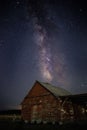 Mesmerizing vertical view of the magical starry night over an old wooden barn Royalty Free Stock Photo