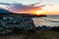 Mesmerizing view of the calm ocean and rocks near the shore during sunset Royalty Free Stock Photo
