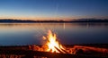Campfire at Dusk Lake, Mountains, and Bonfire Sparks Royalty Free Stock Photo