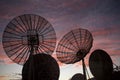 Mesmerizing view of the cloudscape over the satellite dishes on the building roof at sunset Royalty Free Stock Photo