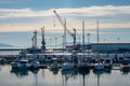 Mesmerizing view of cranes and port work area against a blue sky