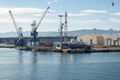 Mesmerizing view of cranes and port work area against a blue sky