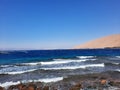 The mesmerizing view of the deep blue waters of Haql beach in Saudi Arabia. Royalty Free Stock Photo