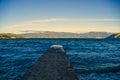 Mesmerizing view of a dock in the lake and mountains during the sunset Royalty Free Stock Photo