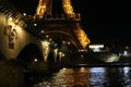 Mesmerizing view of the Eiffel Tower at night near the bridge over a river