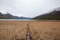 Mesmerizing view of the Eklutna Lake, Alaska:high snowy mountains and meadow of lawn with a waterway Royalty Free Stock Photo