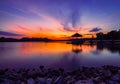 Mesmerizing view of a gazebo over the lake water with trees in the background at sunset Royalty Free Stock Photo