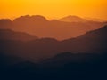 Mesmerizing view of the high hills on a foggy day at sunset Royalty Free Stock Photo