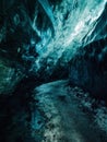 Mesmerizing view inside a blue ice cave with textured walls and a frozen path. Royalty Free Stock Photo