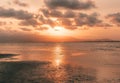 Mesmerizing view of a light orange shaded sunset on the sea