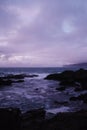Mesmerizing view of rocks in the ocean under the purple sky located in Lion Park, Taiwan