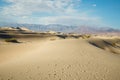 Mesquite Flat Sand Dunes, mountains, and cloudy sky, Death Valley National Park, CA Royalty Free Stock Photo