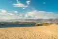 Mesquite Sand Dunes, mountains and cloudy sky background. Death Valley, CA Royalty Free Stock Photo