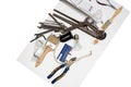 A mess of construction tools, drill, wrench, pliers, wire cutters, brush, lappochka on a white background. Royalty Free Stock Photo