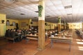 At a mess hall: soldiers sitting at set-out tables and eating Royalty Free Stock Photo