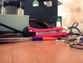 A mess on the table, a red clerical knife and a ballpoint pen in the center, a bottle of glue in the background Royalty Free Stock Photo