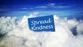 Message on blue notepaper sign on clouds - Spread kindness. Love, compassion, humanity concept with sign onn cloud in the sky.