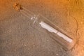 Message in a bottle in the sand of the beach Royalty Free Stock Photo