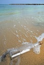 Message in a bottle in the sand of the beach Royalty Free Stock Photo