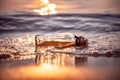 Message in the bottle against the Sun setting down Royalty Free Stock Photo